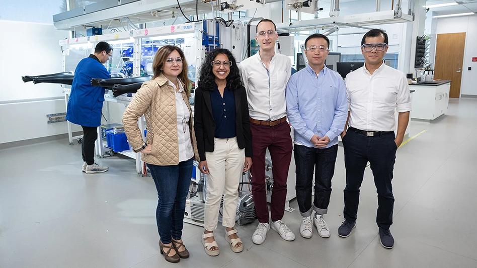 Several people standing in a laboratory